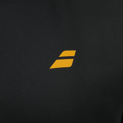 A small, stylized yellow “S” logo is centered on a black textured background—echoing the crisp design details of the Babolat Perf Mens Padel Jacket - Black by Babolat, a lightweight and breathable jacket designed for performance both on and off the court.