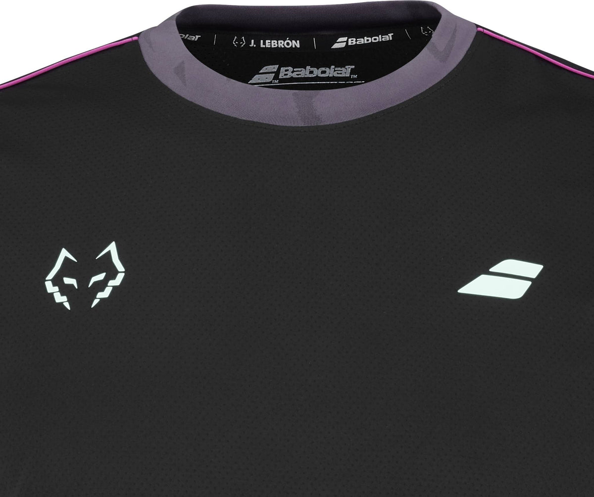 The Babolat Juan Lebron Crew Neck Mens Padel T-Shirt - Black features a white fox head logo, geometric emblem, “J. Lebrón” branding, and purple-pink trim—ideal as a breathable padel t-shirt.