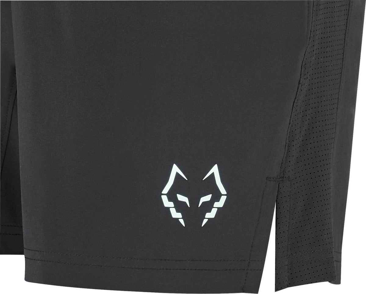 Close-up of Babolat Juan Lebron Mens Padel Shorts - Black with a white wolf head logo on the lower left leg, mesh side panels for breathability, and lightweight stretch fabric.