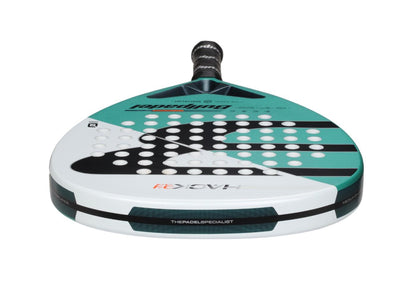The Bullpadel Hack Junior 25 Padel Racket in teal and white features a diamond head shape perfect for advanced junior players. Its geometric patterns and holes, combined with a black handle, enhance style while the Carbon Tube frame boosts durability and performance.