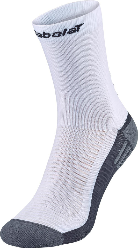 A single white Babolat Mid-Calf Padel Sock with black branding and gray accents on the toe and heel, slightly raised as if worn—perfect for padel.