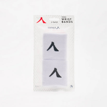 A clear plastic package contains two absorbent white wristbands, each with a black symbol. The packaging is labeled "Kanso 7cm Wristband - 2 Pack - White," ensuring maximum comfort from the Kanso brand.