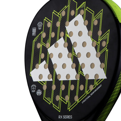 A close-up of the ADIDAS RX Series Padel Racket in lime reveals a geometric design with black and yellow accents. The racket's fiberglass construction is highlighted by a pattern of small holes, adding to its distinct appearance.