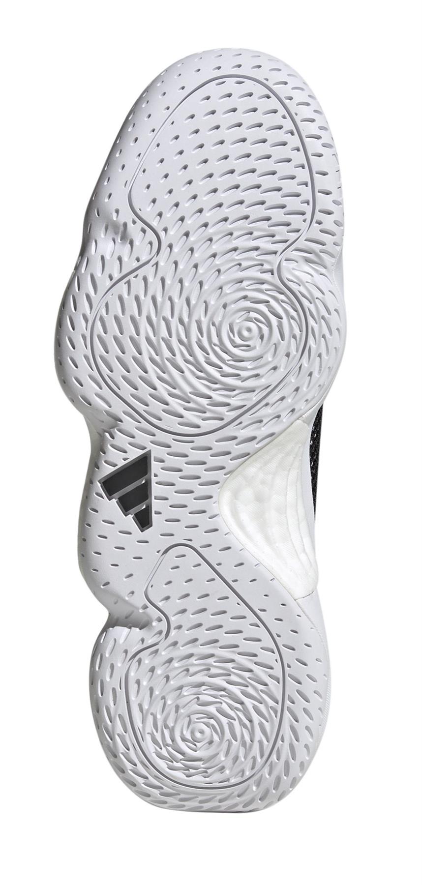 The image features the sole of an ADIDAS Stabil 16 Mens Padel Shoe. It displays intricate patterns with circular grooves and lines, a black adidas logo near the center, and is enhanced with a BOOST midsole for superior comfort.