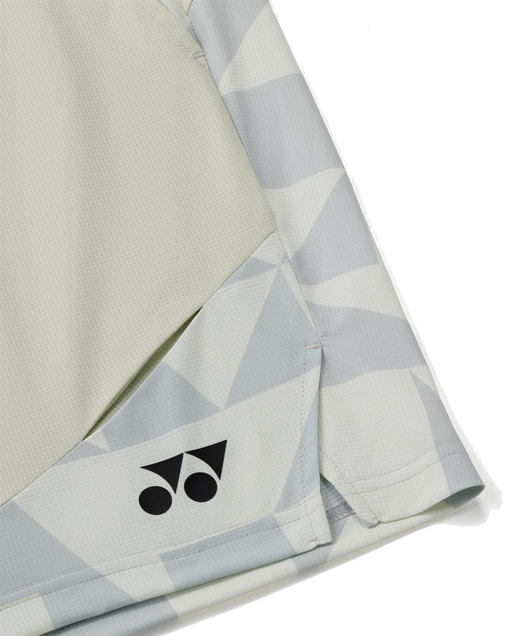 A close-up of Yonex 15240YX Knit Men's Padel Shorts in champagne, featuring a geometric pattern, black logo by the hem, and visible stitching that highlights their quality and breathable comfort for padel players.