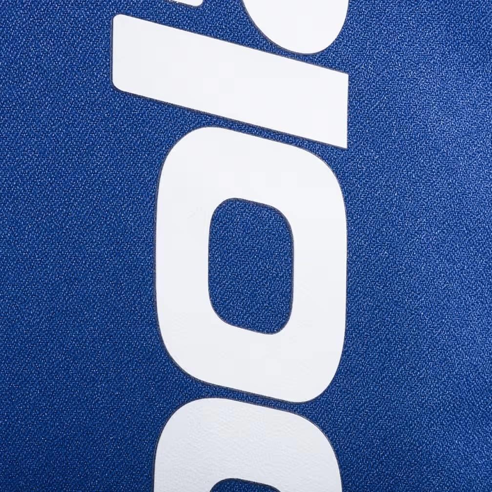 Close-up of bold white text on a blue textured background, likely fabric from the Babolat Court Lite Padel Backpack - Dark Blue. Only parts of the letters "O" and "I" are clearly visible near the racket compartment. Brand: Babolat.