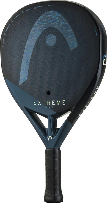 The HEAD Extreme One 2025 Padel Racket in black/blue features "EXTREME" on the face, a textured grip, durable 12K Carbon Fibre construction, and the HEAD logo near the top.