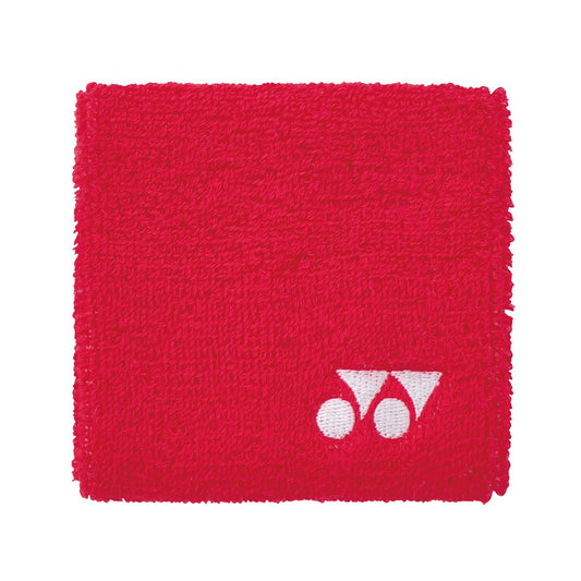 Introducing the Yonex AC493 Padel Wristband in red, from the renowned brand Yonex. This square wrist sweatband features a distinctive white logo with two circles and a triangular shape located in the lower right corner. Crafted from soft, textured fabric, it promises to keep you cool and dry during your workouts.