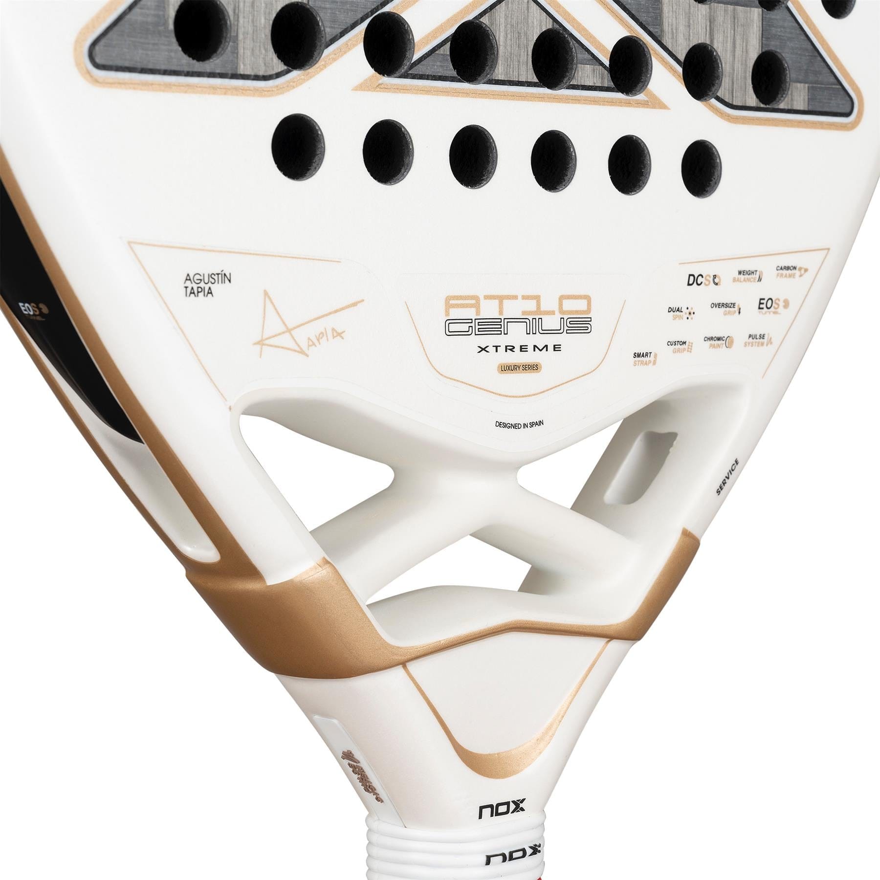Close-up of the NOX AT10 Genius 12K Alum Extrem By Agustín Tapia 2026 Padel Racket, showing gold accents, geometric cutouts, "AT10 Genius" branding, technical specs, and Agustín Tapia’s name near the throat.