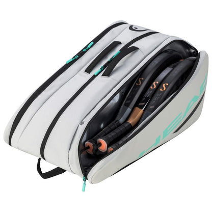 The HEAD Tour Padel Bag L - CCTE, in gray and white, features a backpack carry system and black zippers. It includes a side handle with light blue branding and protects your gear with CCT+ climate control. The bag is partially open, revealing several rackets inside.