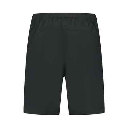 Back view of the plain black K-Swiss Hypercourt 7" Men's Padel Shorts, made from four-way stretch polyester with an elastic waistband. Logo-free and adaptable, they are designed for versatility and simplicity.