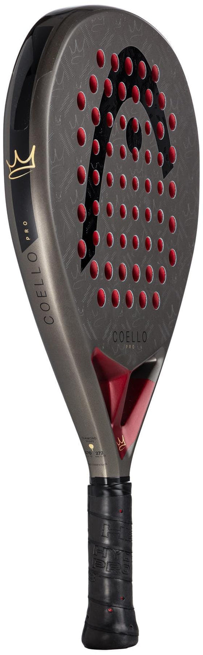 The HEAD Coello Pro 2026 Padel Racket in black and red features a crown logo, carbon hybrid surface, circular face holes, and a textured handle for superior grip.
