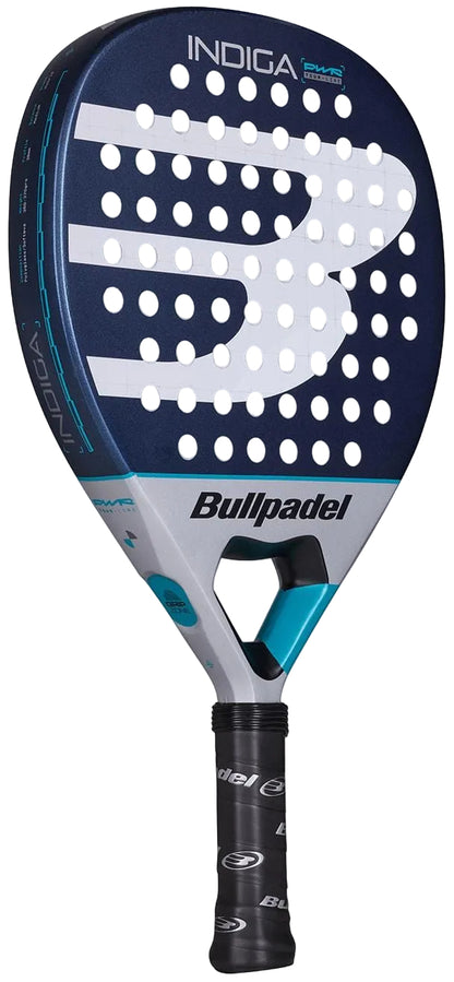 The Bullpadel Indiga Pwr 2026 Padel Racket by Bullpadel features a dark blue and silver design with a large white "B" logo on the face and a black grip, designed for power on the court.