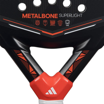 Close-up of the adidas Metalbone Superlight 2026 padel racket in black and red, displaying "METALBONE SUPERLIGHT" text, icons, and geometric patterns—a top pick for players seeking a lightweight racket.