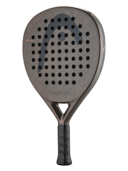 A close-up of the HEAD Coello Vibe 2026 Padel Racket shows its dark, patterned surface with circular holes, black grip, and "HEAD" branding—perfect as a fibreglass padel racket for beginners.