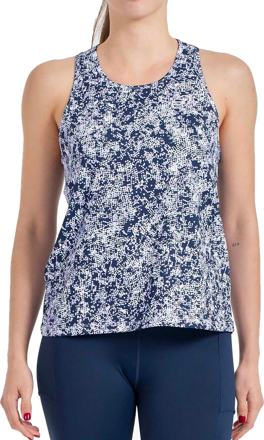A woman models the Bullpadel Pilme Women's Padel Tank Top in Deep Ocean—sleeveless, blue and white patterned—paired with navy leggings. Her face is not shown. Breathable performance sportswear by Bullpadel.
