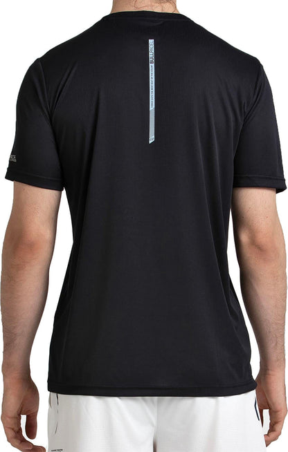 A person is shown from the back wearing a black Bullpadel Cabore Men's Padel T-Shirt by Bullpadel and white shorts. The quick-dry shirt features a small vertical text strip near the upper center of the back.