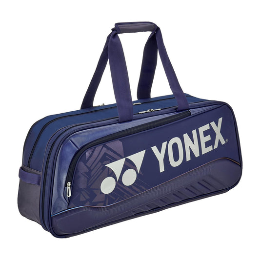 The Yonex 02531WEX Expert Tournament Padel Bag in navy blue features a rectangular design with two handles, a zippered main compartment, and showcases the Yonex logo and brand name on the side.