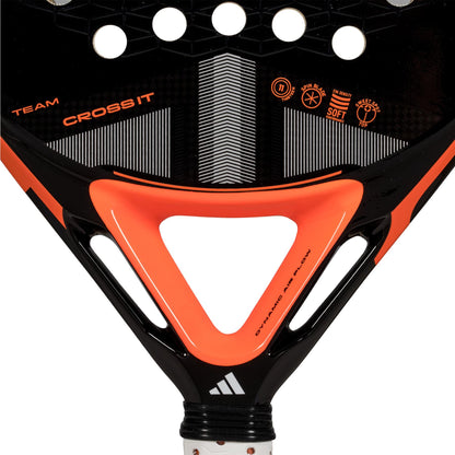 Close-up of the ADIDAS Cross It Team 3.4 padel racket head in black and orange, featuring the adidas brand name and logos. The design has circular cutouts for airflow, a triangular pattern with "TEAM CROSS IT," perfect for advanced players.