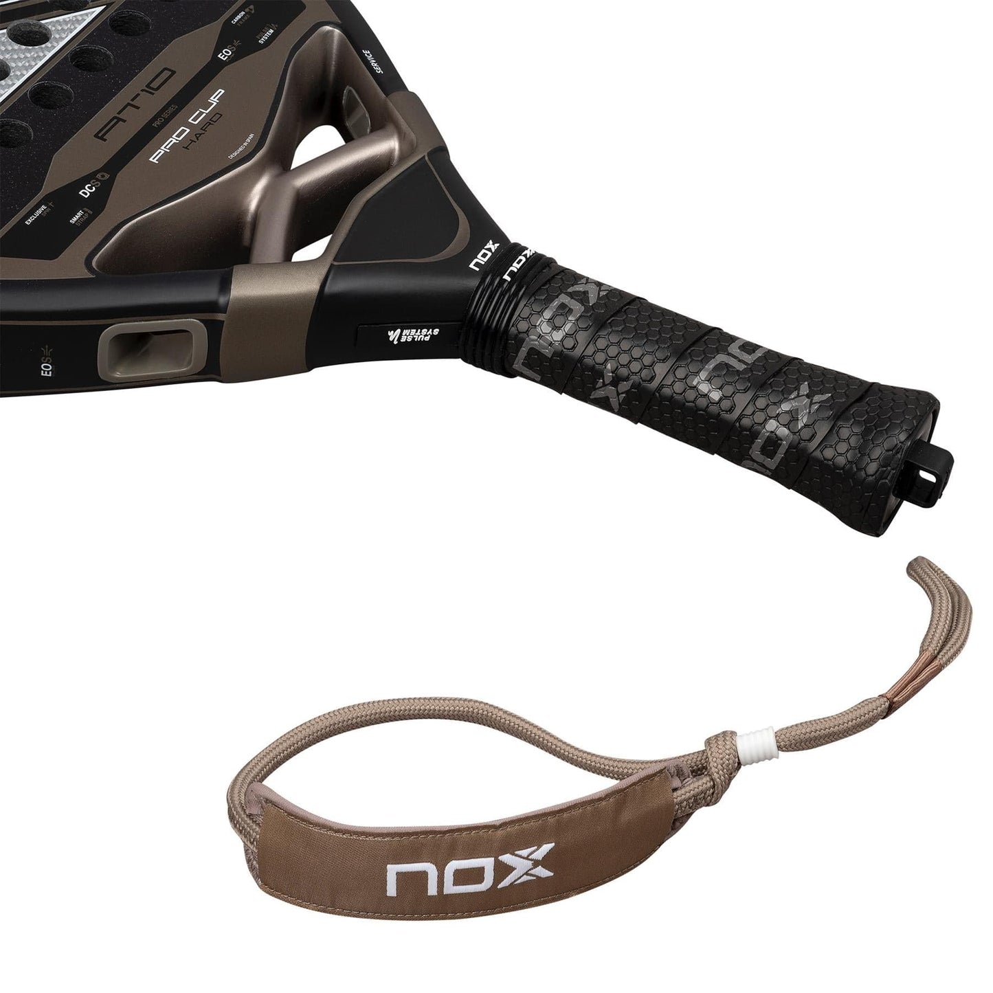 Close-up of the handle and wrist strap of the NOX AT10 Pro Cup Hard By Agustín Tapia 2026 padel racket, showing a black textured grip and detachable brown and beige strap with the NOX logo.