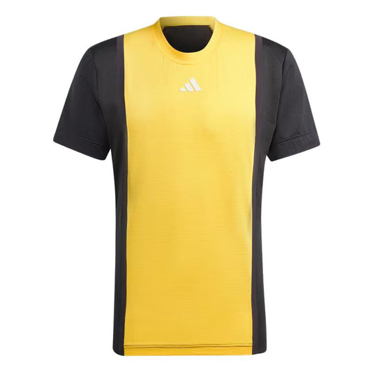 An adidas Mens Pro Freelift 3D Padel T-Shirt in Spark Yellow with black accents on the sides and sleeves is designed for an enhanced fit. Featuring a small white logo centered on the chest, this shirt exemplifies cutting-edge athletic wear design.