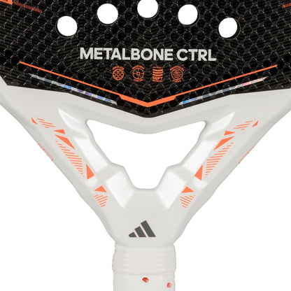 Close-up of the adidas Metalbone Ctrl 2026 Padel Racket - Black, showing its "METALBONE CTRL" text, black textured surface with orange geometric highlights, white handle with adidas logo, and innovative adjustable weight system.