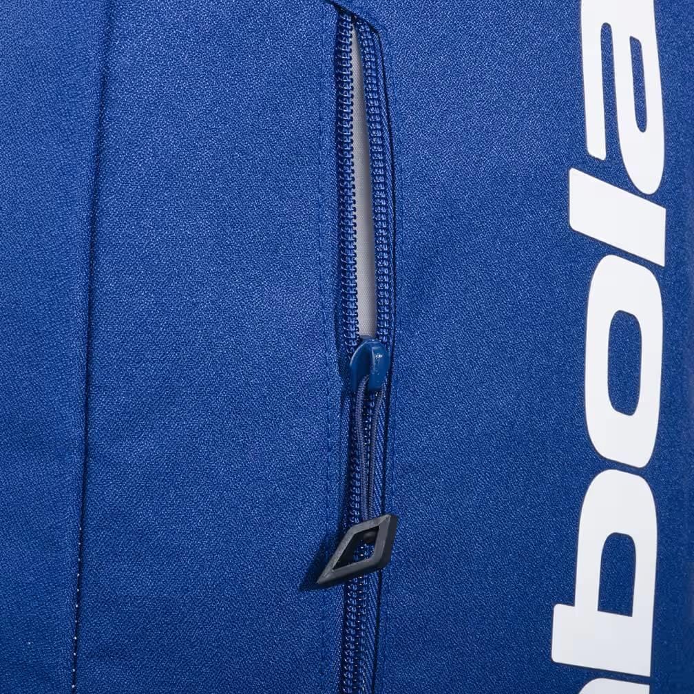Close-up of the Babolat Court Lite Padel Backpack - Dark Blue, featuring a partially open zippered pocket and visible white Babolat logo, showcasing its practical racket compartment design.