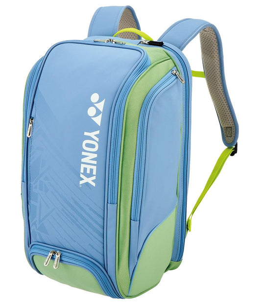 The Yonex 02512EX Expert Padel Backpack in Smoke Blue features multiple zippered compartments and the classic Yonex logo. It has adjustable shoulder straps and combines solid colors with subtle patterns for a stylish racket bag choice.