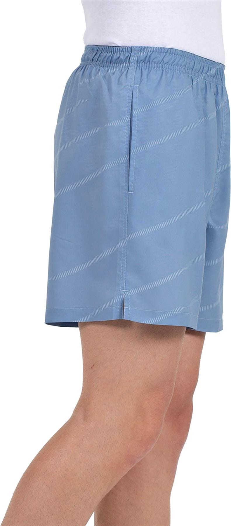A person in Bullpadel Cabanas Men's Padel Shorts, Shadow Blue, with a subtle stripe pattern and white shirt, shown waist to above the knee (profile view)—ideal for padel thanks to Bullpadel's Quickerdry technology.