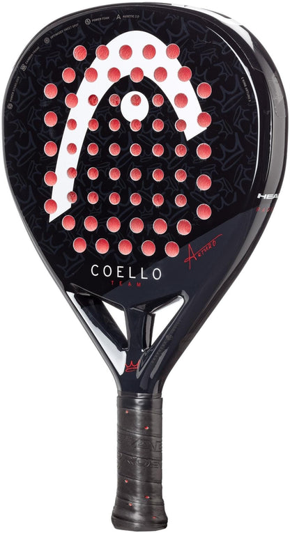 The HEAD Coello Team 2025 Padel Racket in black features red circular holes, “COELLO TEAM” on the face, Power Foam for power, a textured grip, Auxetic 2.0 technology, and subtle patterned details. Brand: HEAD.