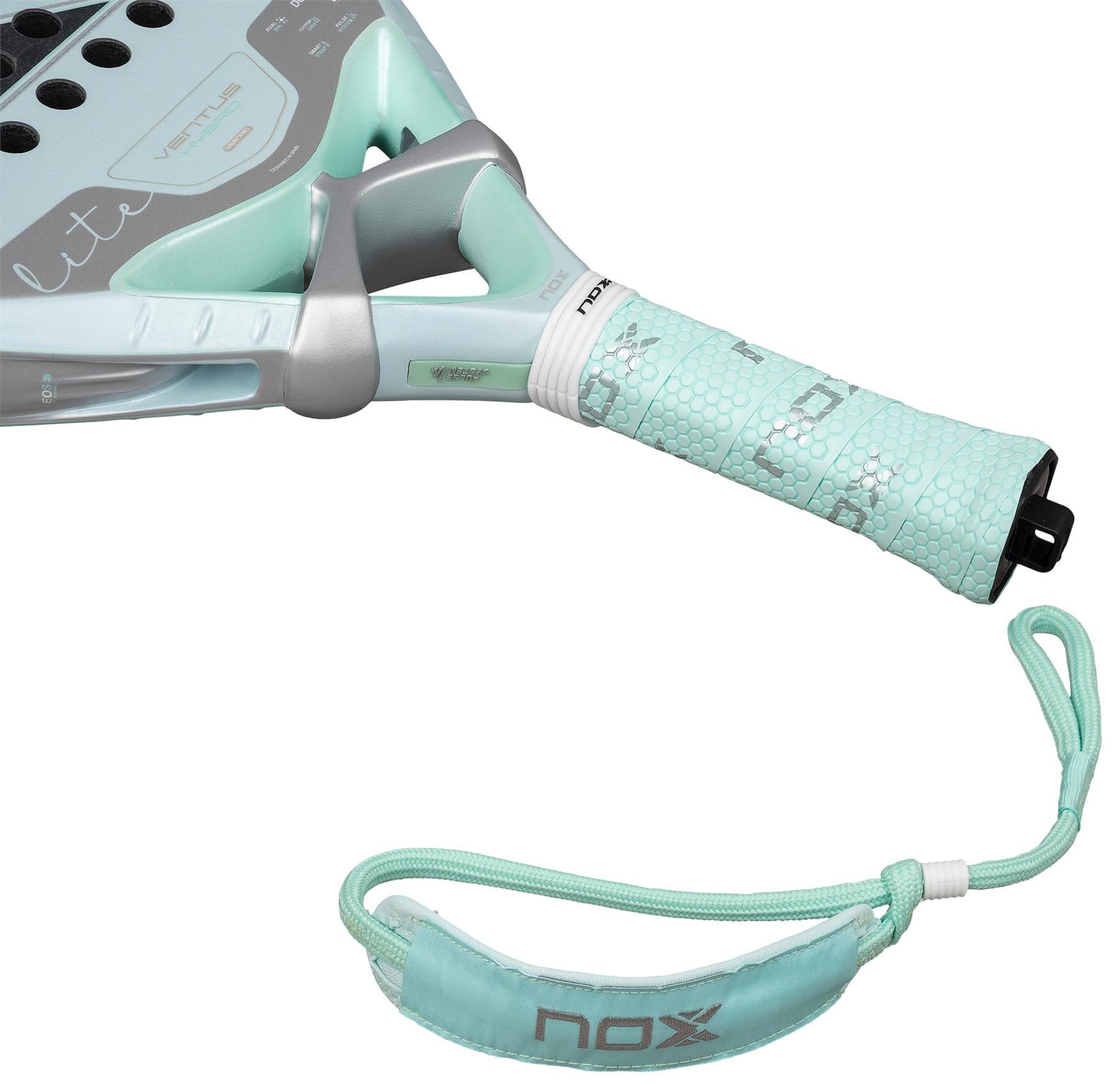 Close-up of the NOX Luxury Ventus 12K Hybrid Lite 2026 Padel Racket – Blue handle, featuring a textured grip, "NOX" wrist strap, hexagonal patterns, metallic accents, and durable 12K carbon fibre construction.
