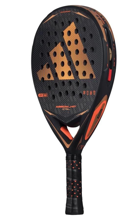 The adidas Arrow Hit CTRL 2026 padel racket features a perforated black and orange face, textured grip, intelligent balance system, and an orange adidas logo on the front.