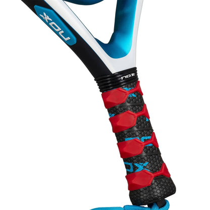 Close-up of a NOX Equation Soft Advanced 2026 Padel Racket handle with a textured black grip, red and blue accents, anti-vibration system, and the NOX brand logo.