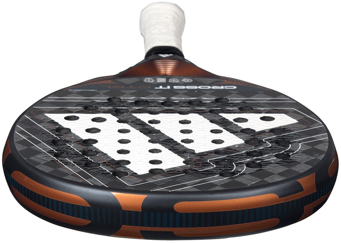 Close-up of the ADIDAS Cross It Ctrl 2026 Padel Racket – Black by adidas, featuring a black and orange design, Spin Blade Mould technology on the perforated hitting surface, and a white grip handle.