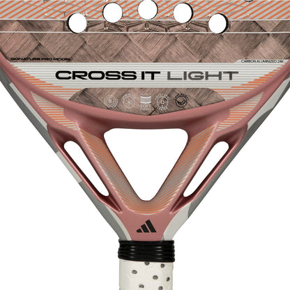 Close-up of the adidas Cross It Light 2026 Padel Racket in white and pink, featuring a carbon fibre frame, patterned surface, brand details near the handle, and Spin Blade Mould technology.