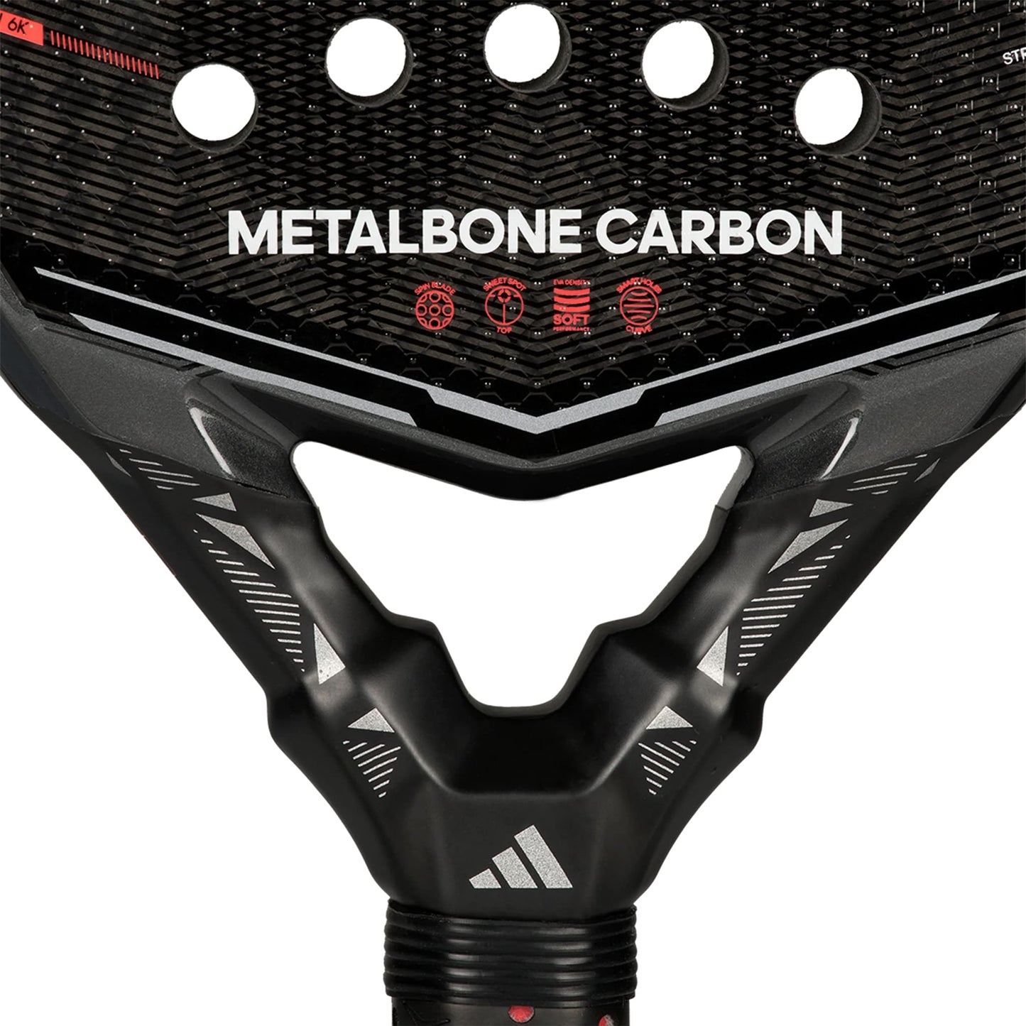 Close-up of the adidas Metalbone Carbon 2026 padel racket for advanced players, with “METALBONE CARBON” on the face, red icons, circular holes, carbon fiber texture, and the adidas logo on the neck.