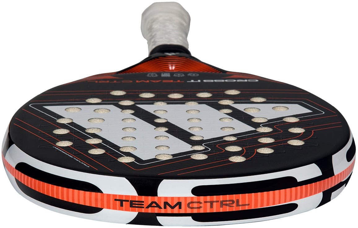 A close-up of the adidas Cross It Team Ctrl 2026 Padel Racket - Black / Orange showcases its perforated surface, Extra Power Grip, and "TEAM CTRL" label near the base.