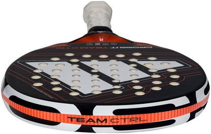 A close-up of the adidas Cross It Team Ctrl 2026 Padel Racket - Black / Orange showcases its perforated surface, Extra Power Grip, and "TEAM CTRL" label near the base.
