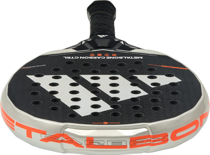 A close-up of the ADIDAS Metalbone Carbon CTRL 2026 Padel Racket by adidas reveals its black surface with circular holes, bold white logo, orange and silver rim details, and a black-gripped handle—an ideal choice for advanced players.
