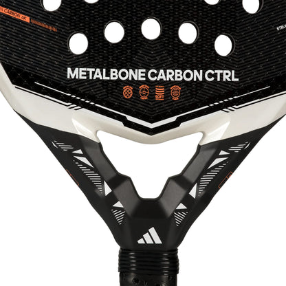 Close-up of the adidas Metalbone Carbon CTRL 2026 padel racket for advanced players, highlighting its textured surface, circular holes, and distinct adidas branding with icons near the handle.