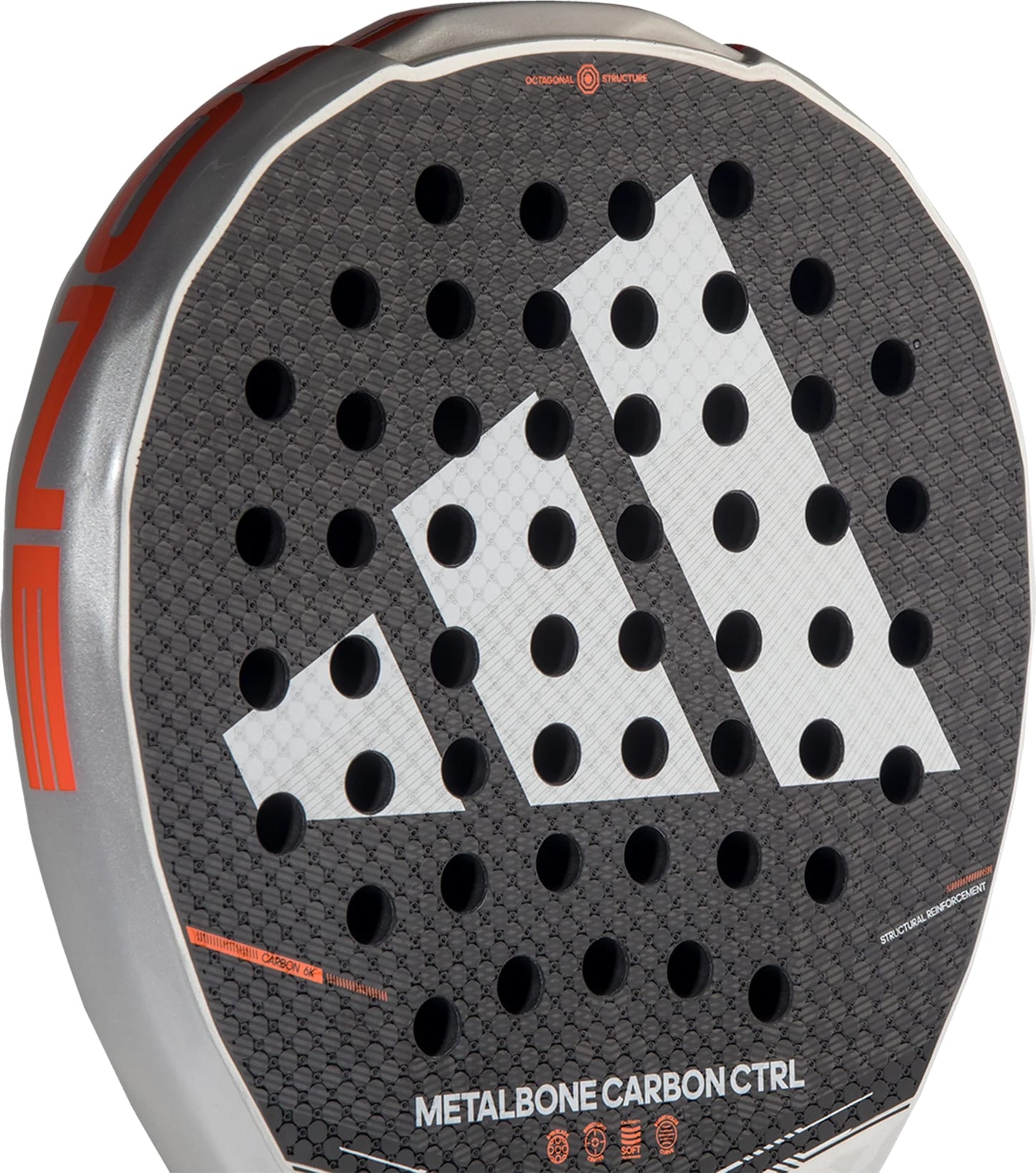 Close-up of the adidas Metalbone Carbon CTRL 2026 padel racket for advanced players, with a large white adidas logo, circular perforations, "METALBONE CARBON CTRL" text at the base, and sleek silver-orange edging.