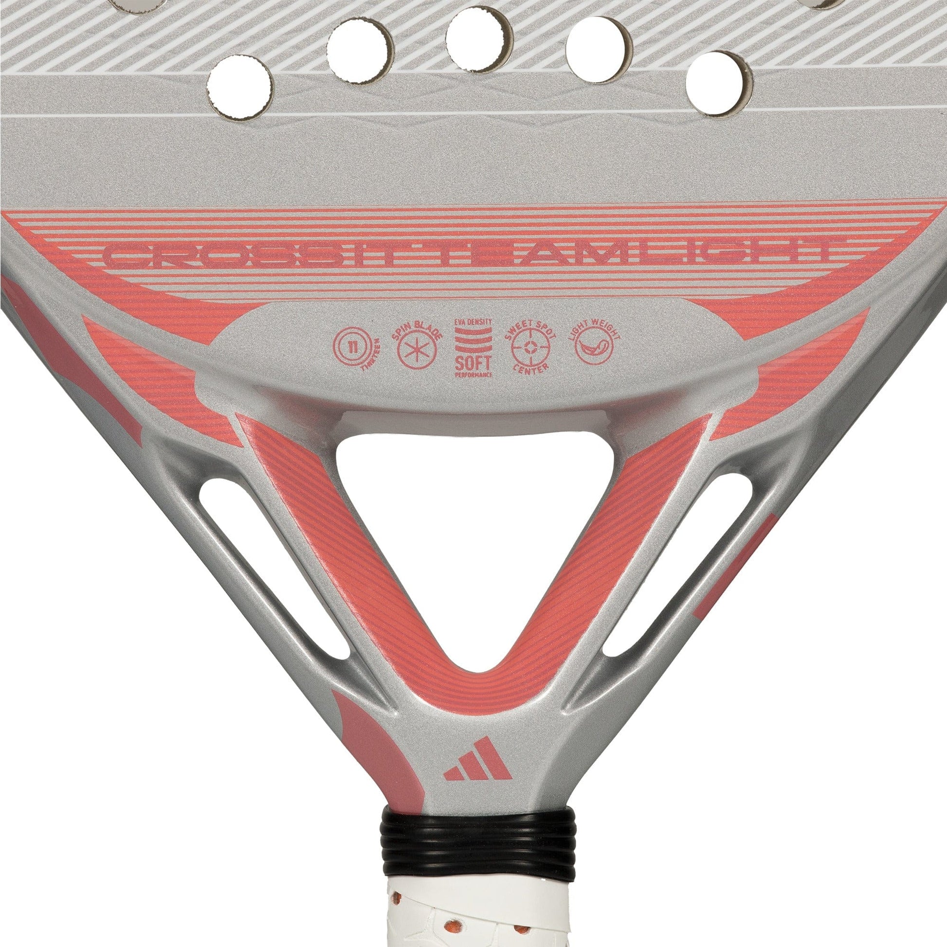 Close-up of the lightweight adidas Cross It Team Light 2026 Padel Racket in white and pink, highlighting the lower part with brand name, technical specs, circular holes, Extra Power Grip, and a partially visible adidas logo on the handle.