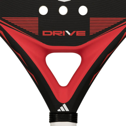 Close-up of the adidas Drive Black 2026 Padel Racket - Black / Red, featuring "DRIVE" at the center, angular red and black patterns, a triangular hole near the handle, and white striping at the base; ideal for beginners.