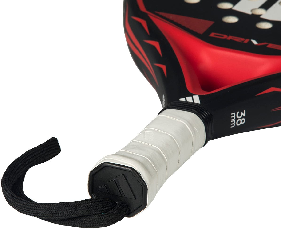 Close-up of the adidas Drive Black 2026 Padel Racket - Black / Red handle with a white grip, black wrist strap, and part of the red and black face. "38 mm" is printed near the handle on this comfortable beginner racket.