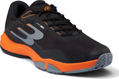 The Bullpadel Hybrid Fly 26I Mens Padel Shoes - Black have orange and gray accents, a mesh upper, chunky sole, side “B” logo with “FAST,” black laces, and textured tread.