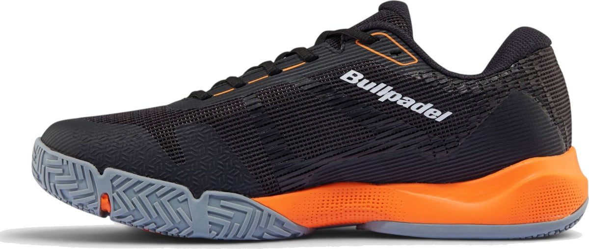 The Bullpadel Hybrid Fly 26I Mens Padel Shoes - Black feature a black design with an orange heel, gray textured sole, white side logo, and low-profile FASTLAB mesh details for breathability.