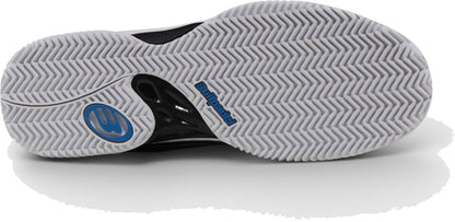 The image shows the white zig-zag sole of Bullpadel Indiga 26I Mens Padel Shoes - Black, featuring a blue circular logo and black heel section with “Bullpadel” branding—ideal for beginner padel players.