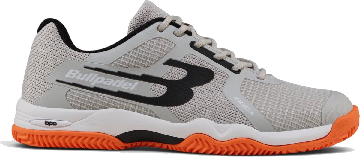 The Bullpadel Indiga 26I Mens Padel Shoes - Orange feature black and white accents, an orange herringbone outsole, breathable mesh upper, bold “B” logo, “Bullpadel” text, white laces, and black inner lining.