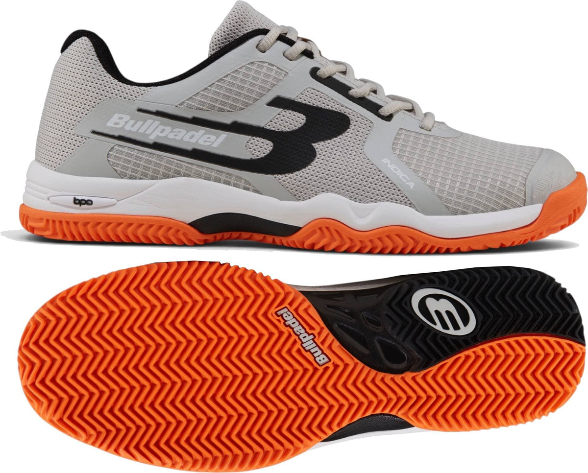The Bullpadel Indiga 26I Mens Padel Shoes - Orange feature gray with black and orange accents, a breathable mesh upper, herringbone outsole tread, and the Bullpadel logo shown from the side and bottom.