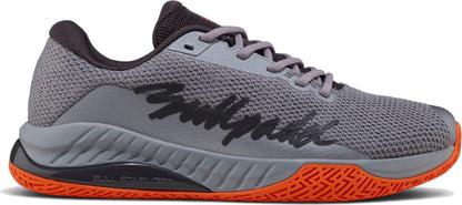 The Bullpadel Ionic 26I Mens Padel Shoes - Dark Grey feature black “Bullpadel” lettering, an orange textured sole, and a mesh upper—ideal for intermediate to advanced players for sport or casual wear.